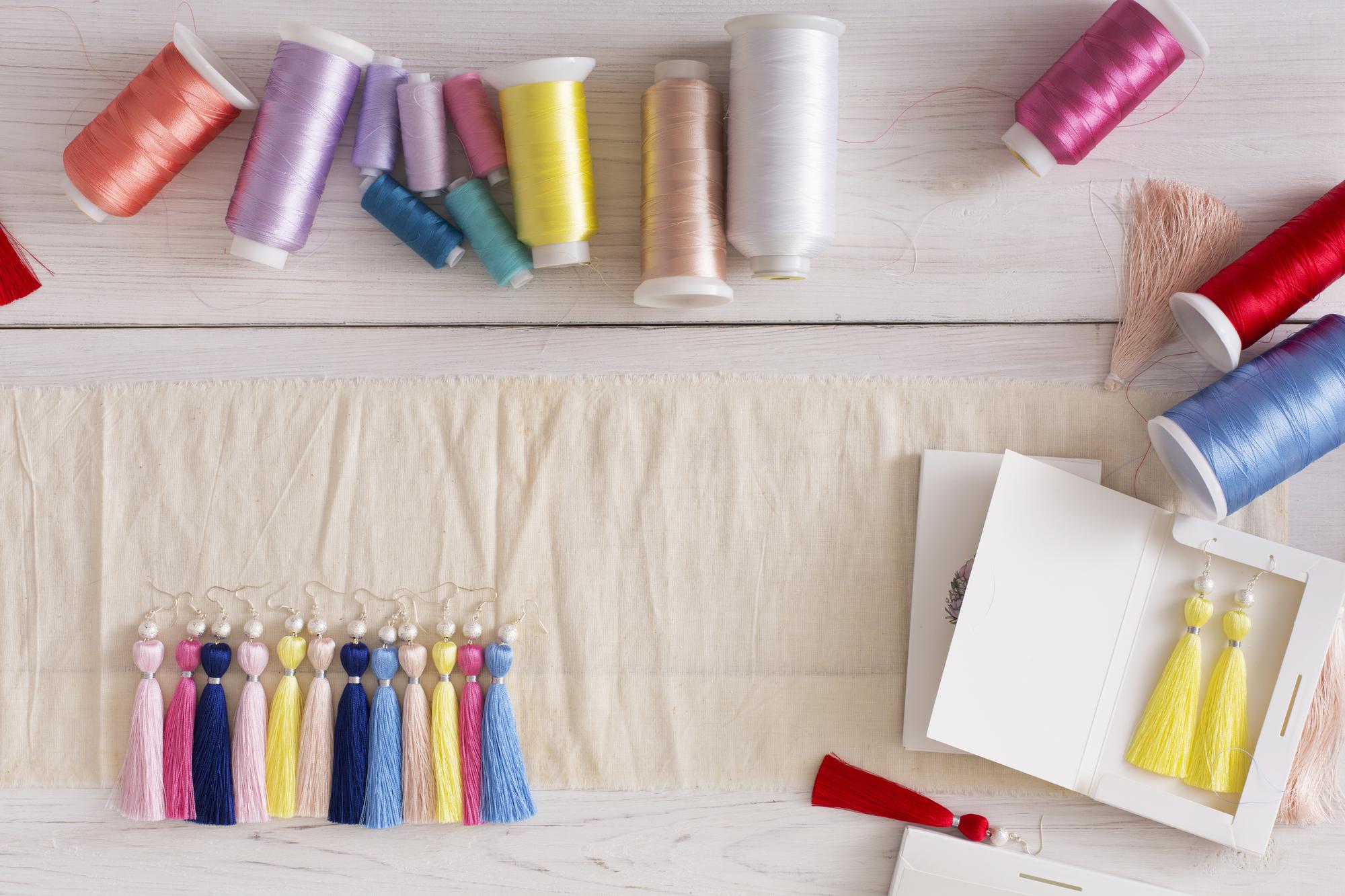 atelier table with threads and embroidered sample