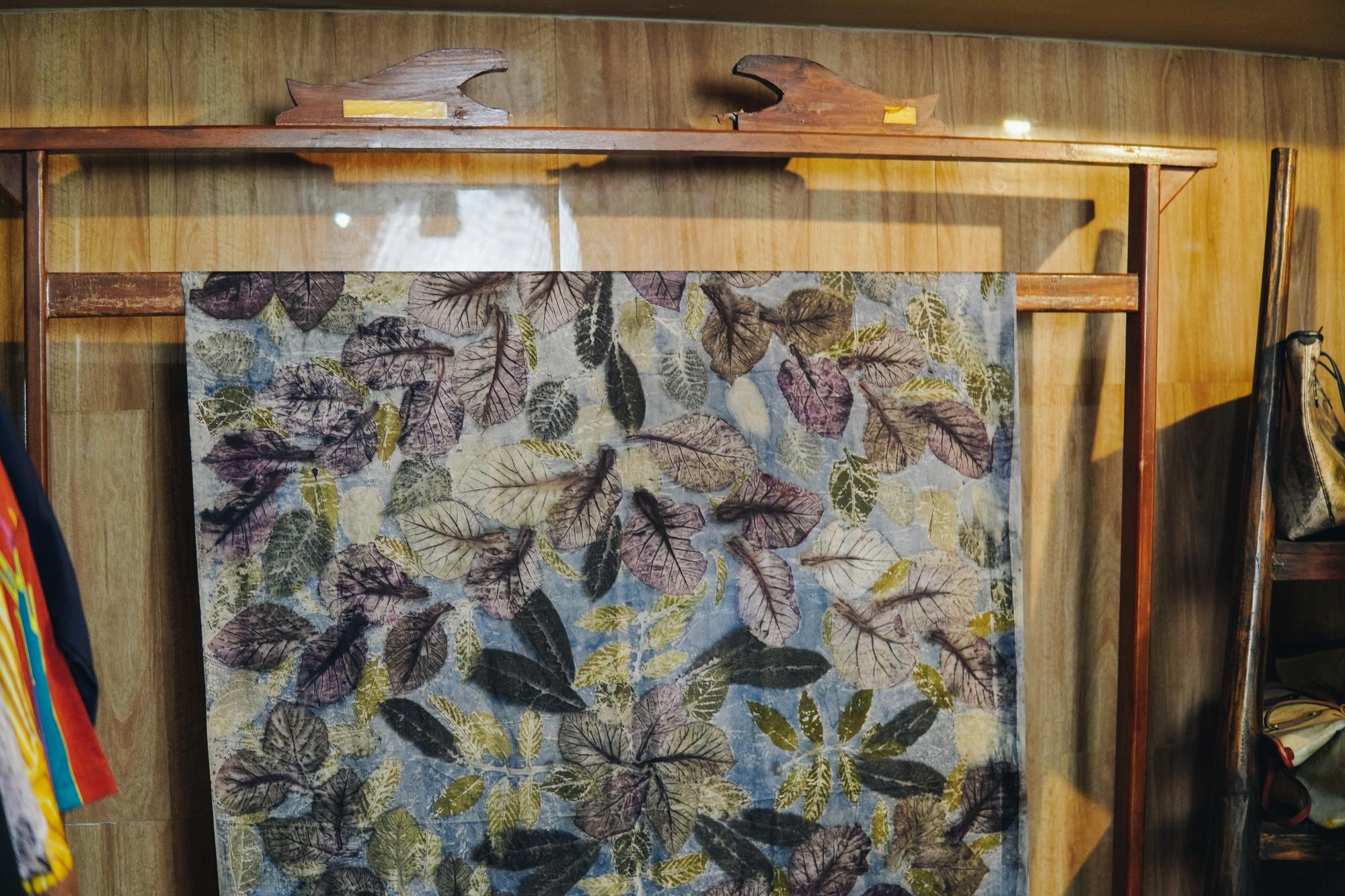 large embroidered textile on frame